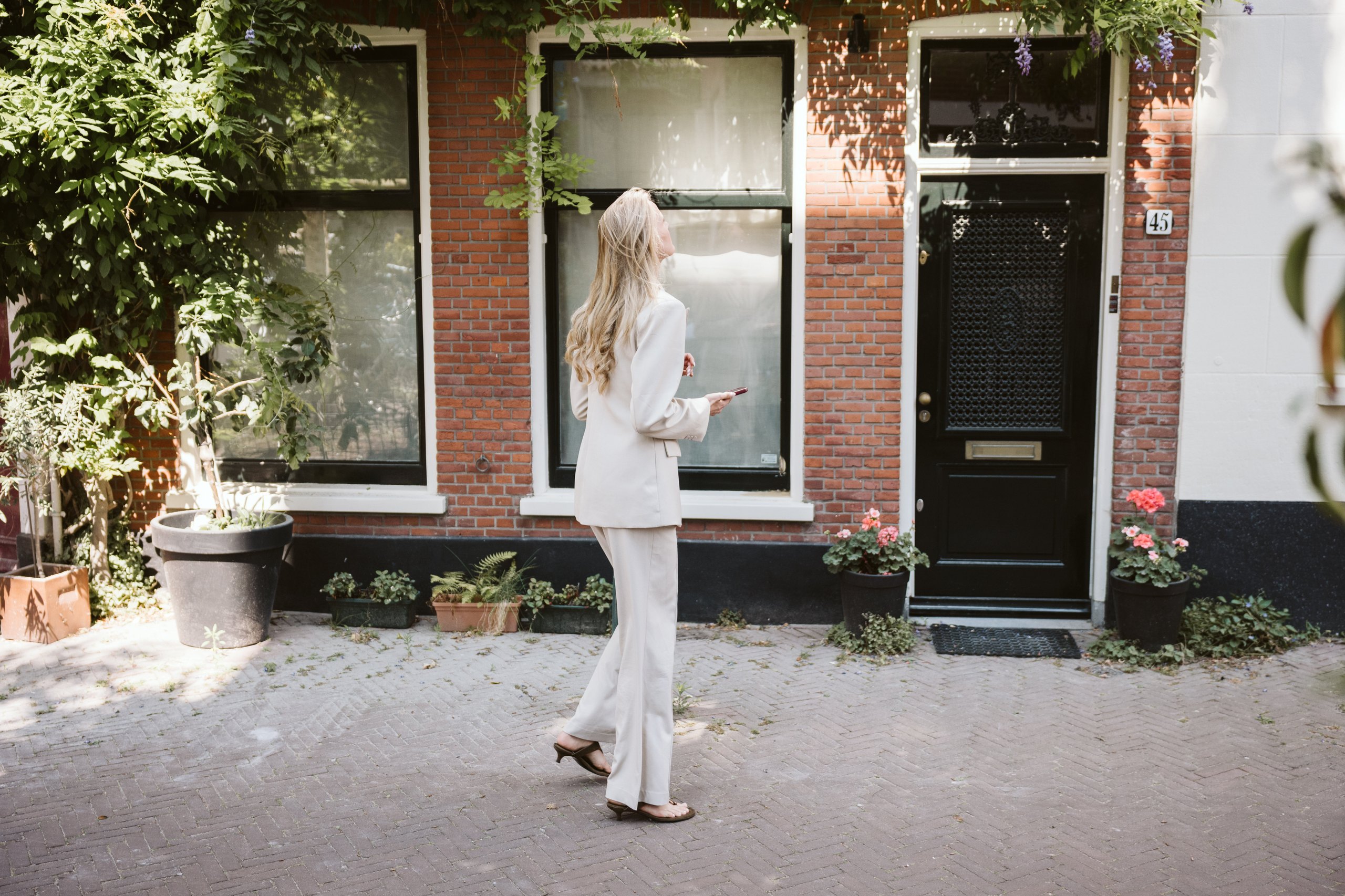 Vrouw loopt voor een woning in Den Haag